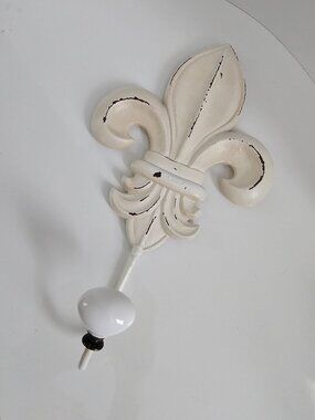 Decorative metal fleur-de-lis hook, cream colored